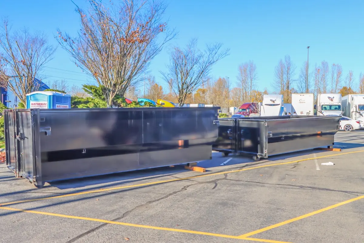 Professional dumpster rental service with roll-off container on residential driveway in Chippewa